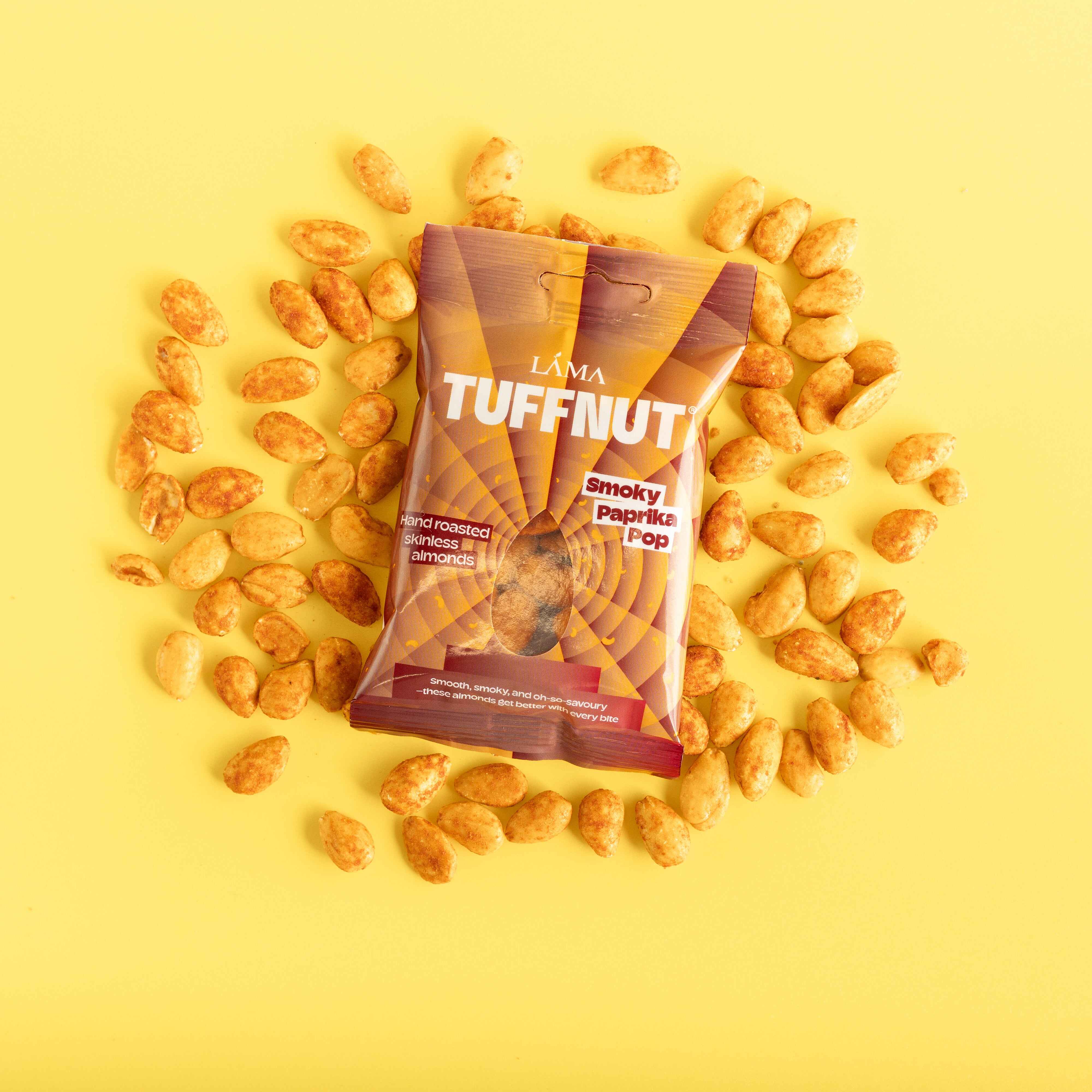 Tuffnut snack pack of smoky paprika pop surrounded by nuts on a yellow background